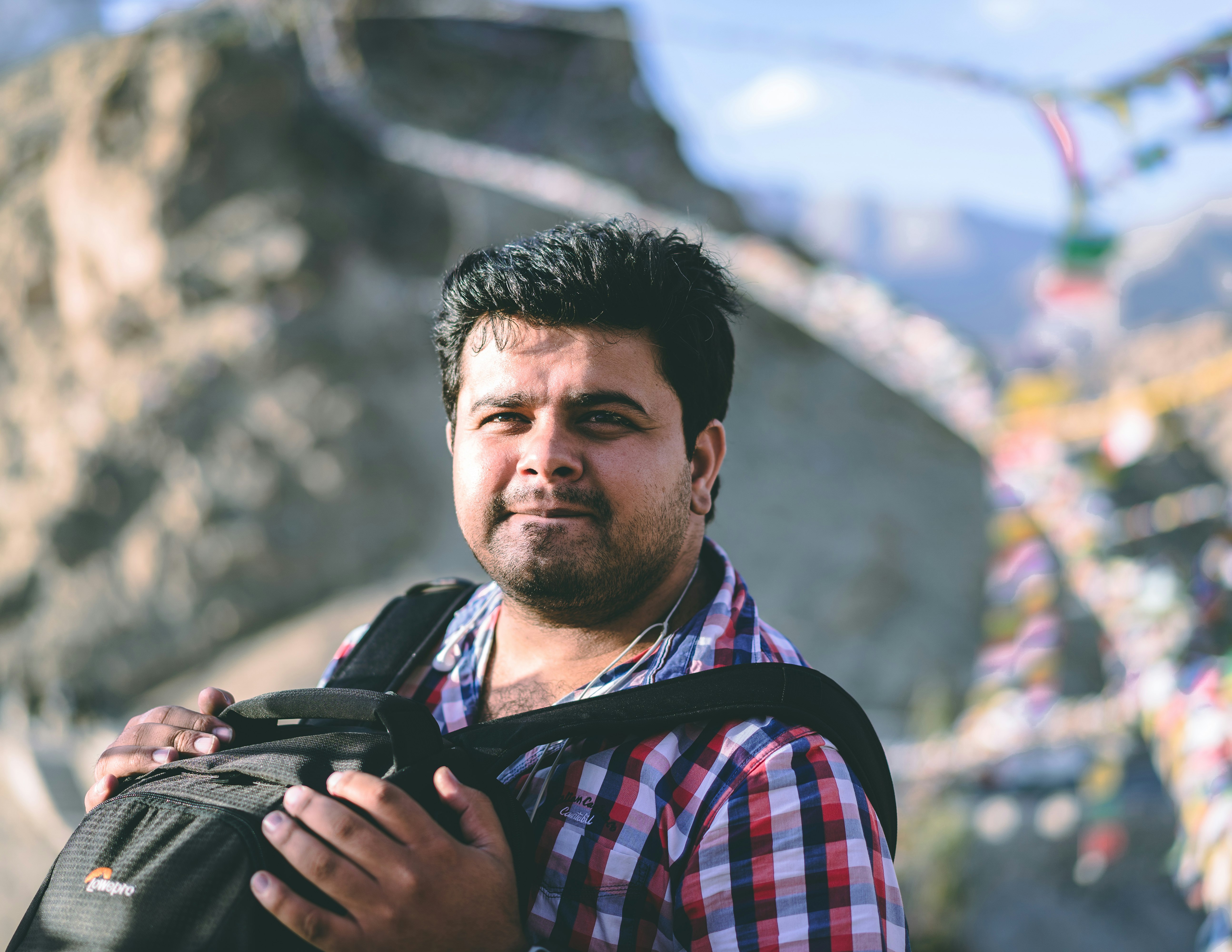 man carrying backpack in selective focus photography